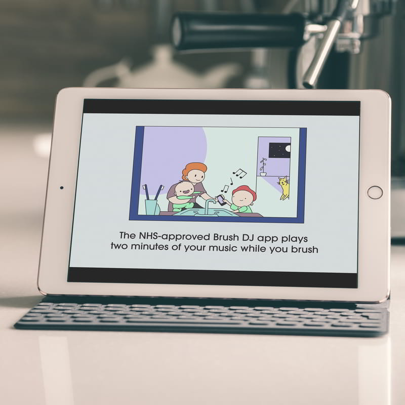An iPad shows a still from an animation where a mother uses the Brush DJ app with her kids at brush time. A caption reads 'The NHS-approved Brush DJ app plays two minutes of your music while you brush'